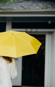 Image of person holding yellow umbrella.