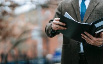 photo of person holding black book